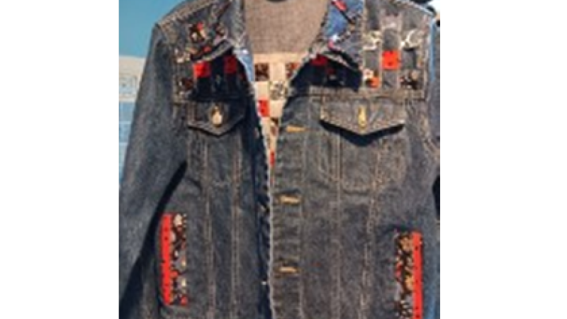 Picture of a denim jacket with added fabric pieces.